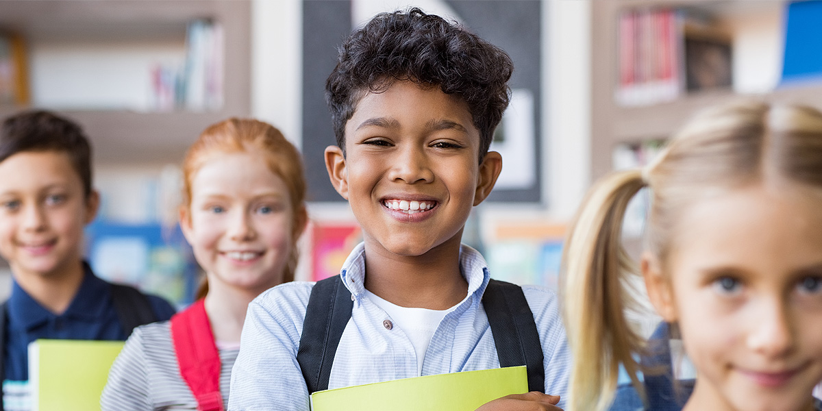 Image of schoolchildren in a classroom  Text: Creating trust. Ensuring safety. Making it easy.